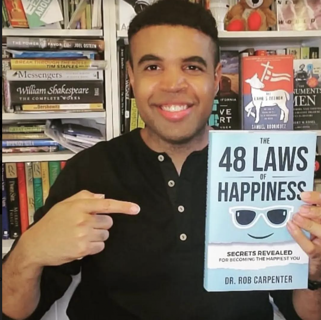 Dr. Rob with his book, "The 48 Laws of Happiness"